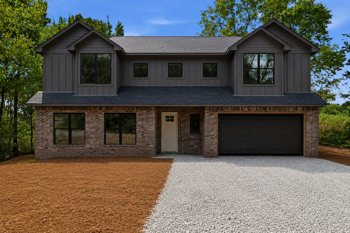 New build exterior before landscaping, bare dirt yard